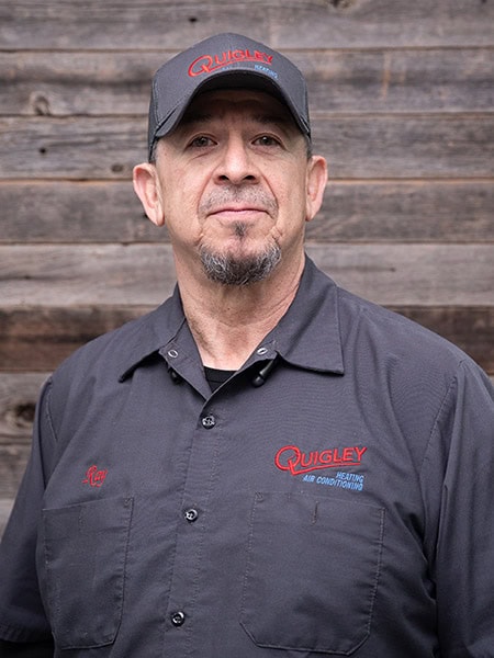 Ray R., a Quigley Heating & Air lead technician, wearing a Quigley uniform